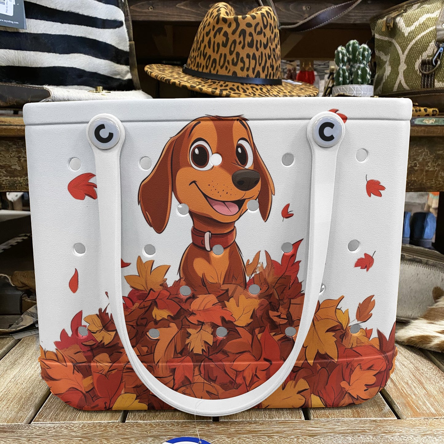 Spheregoods Cee™ Bag Puppy with a pile of autumn leaves