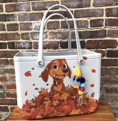 Spheregoods Cee™ Bag Puppy with a pile of autumn leaves